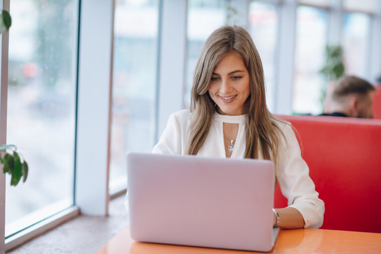 elegant-woman-with-smiling-face-typing-her-laptop